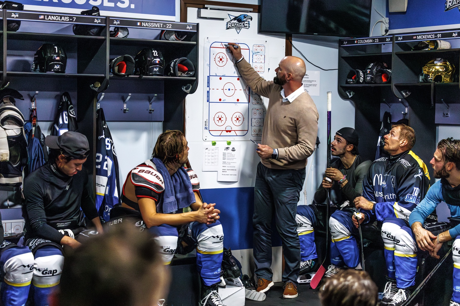 Coach explaining team tactics in the locker room