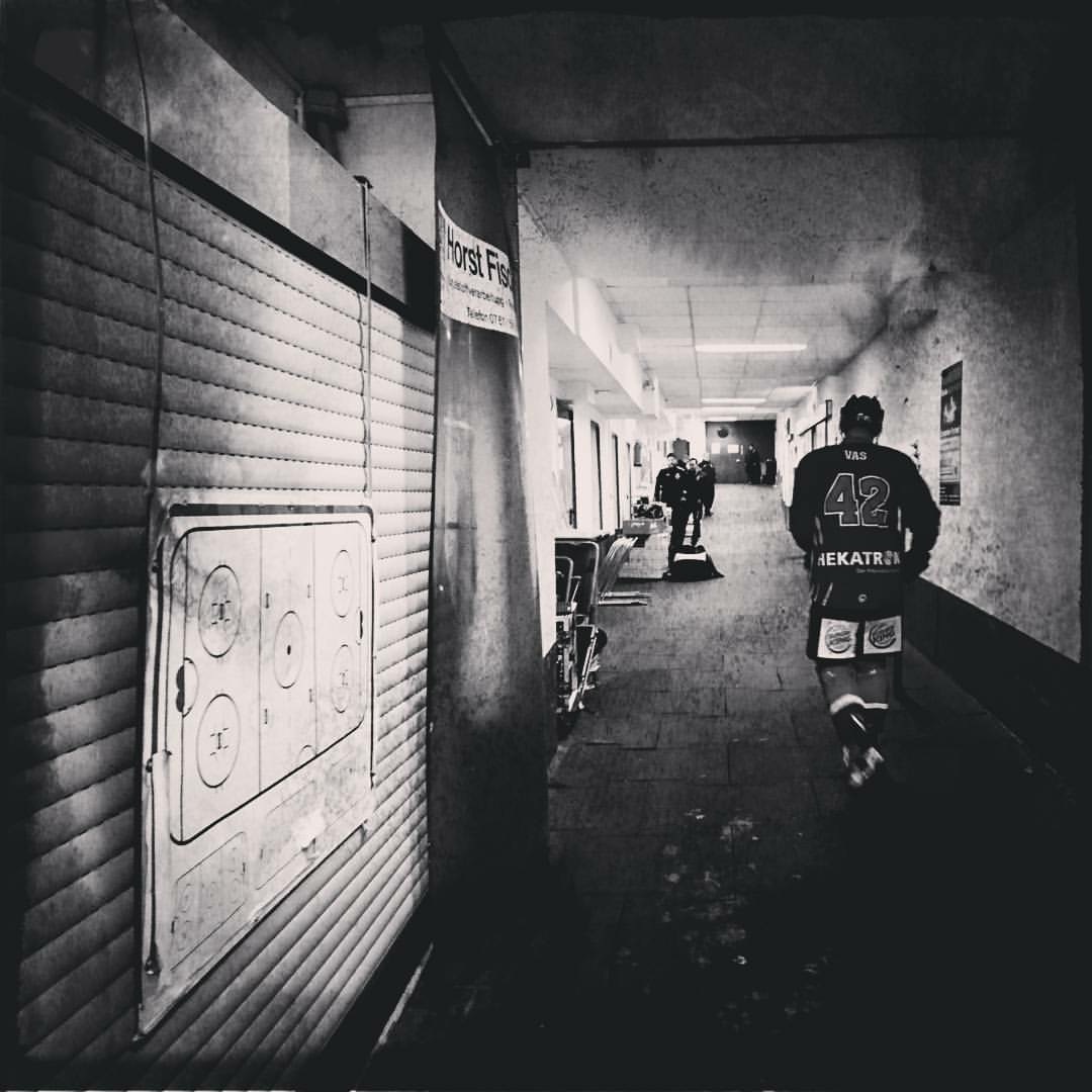 Hockey player number 42 in arena hallway