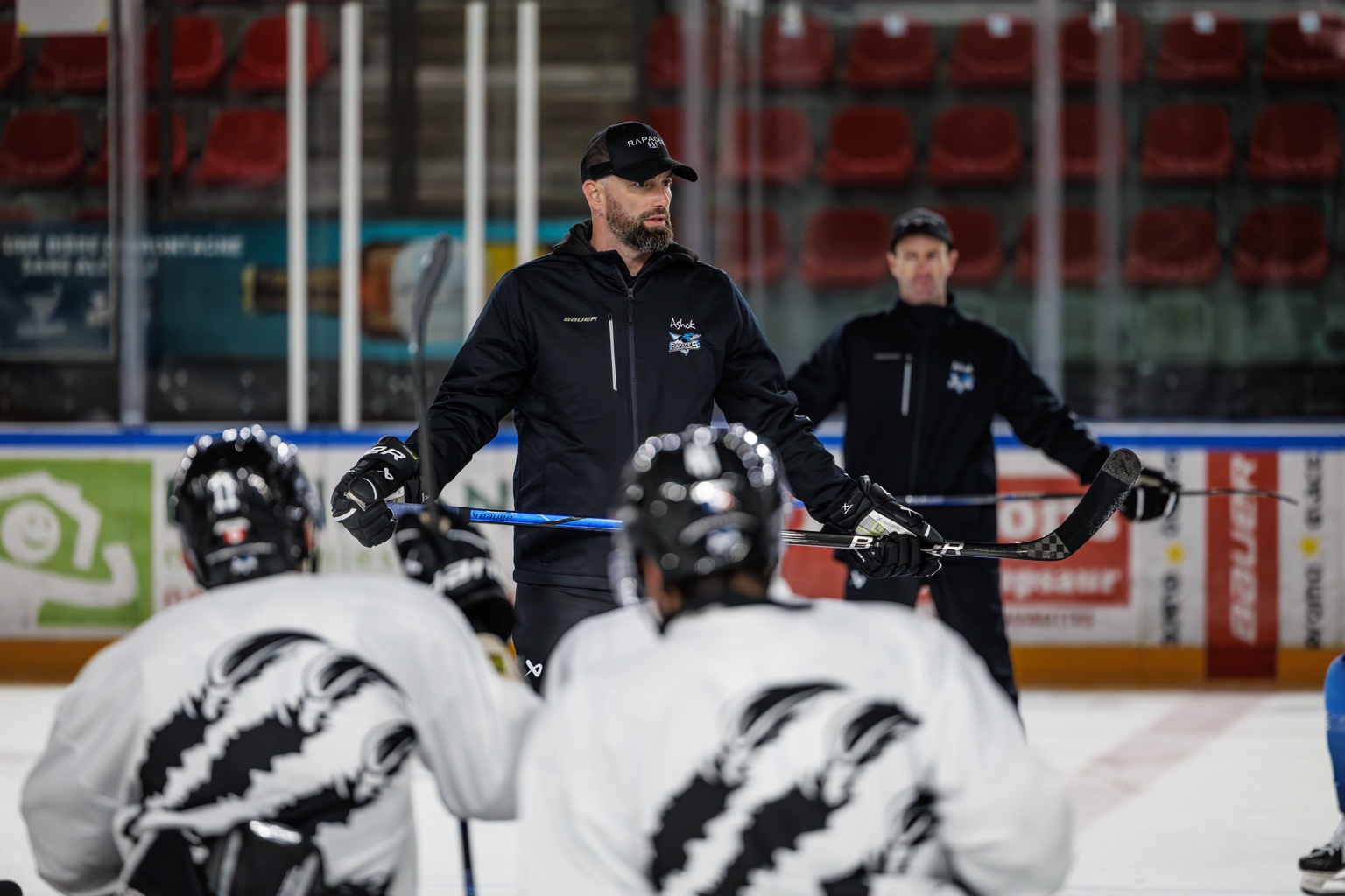 Coach explaining team tactics in the locker room