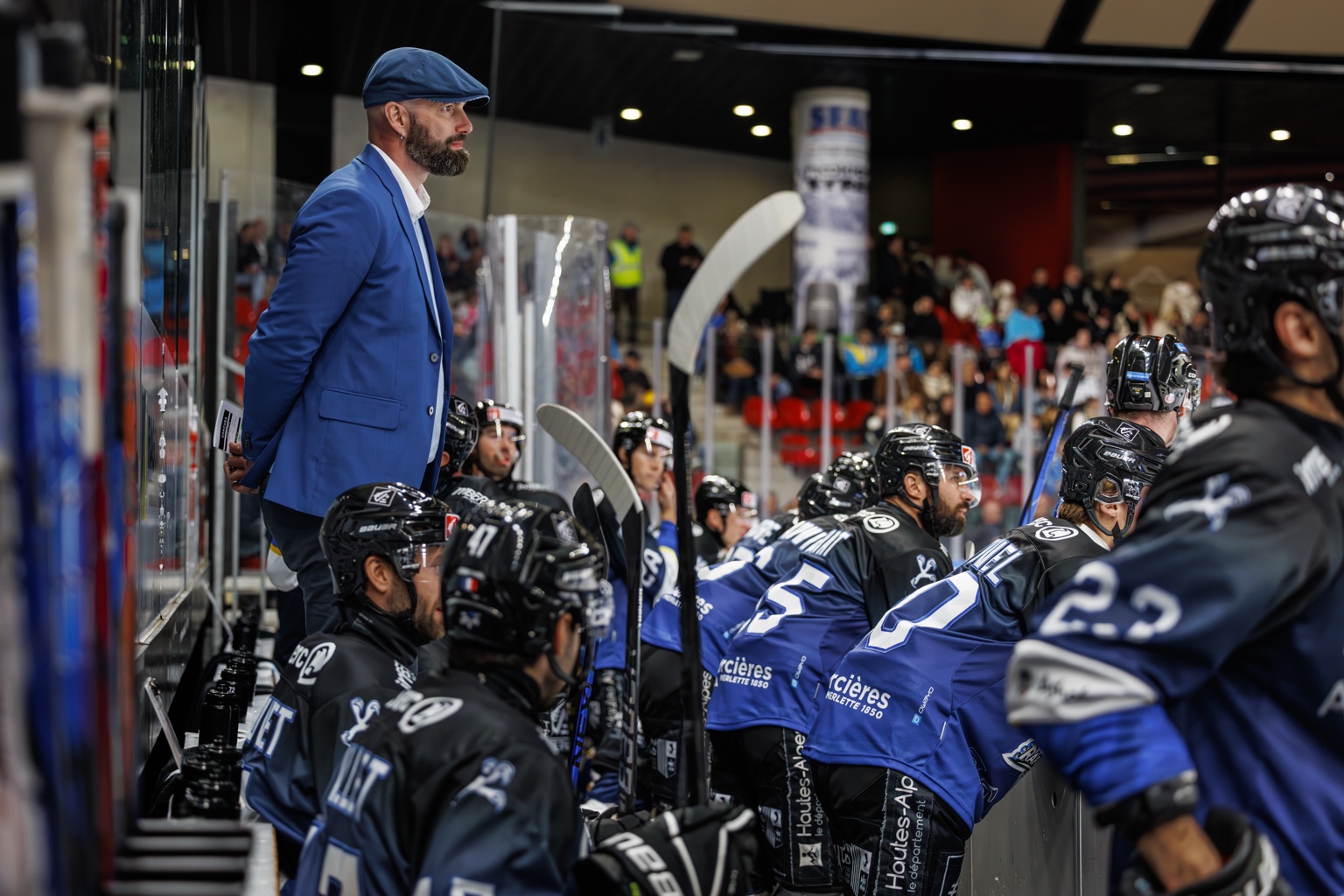 Coach standing behind the bench
