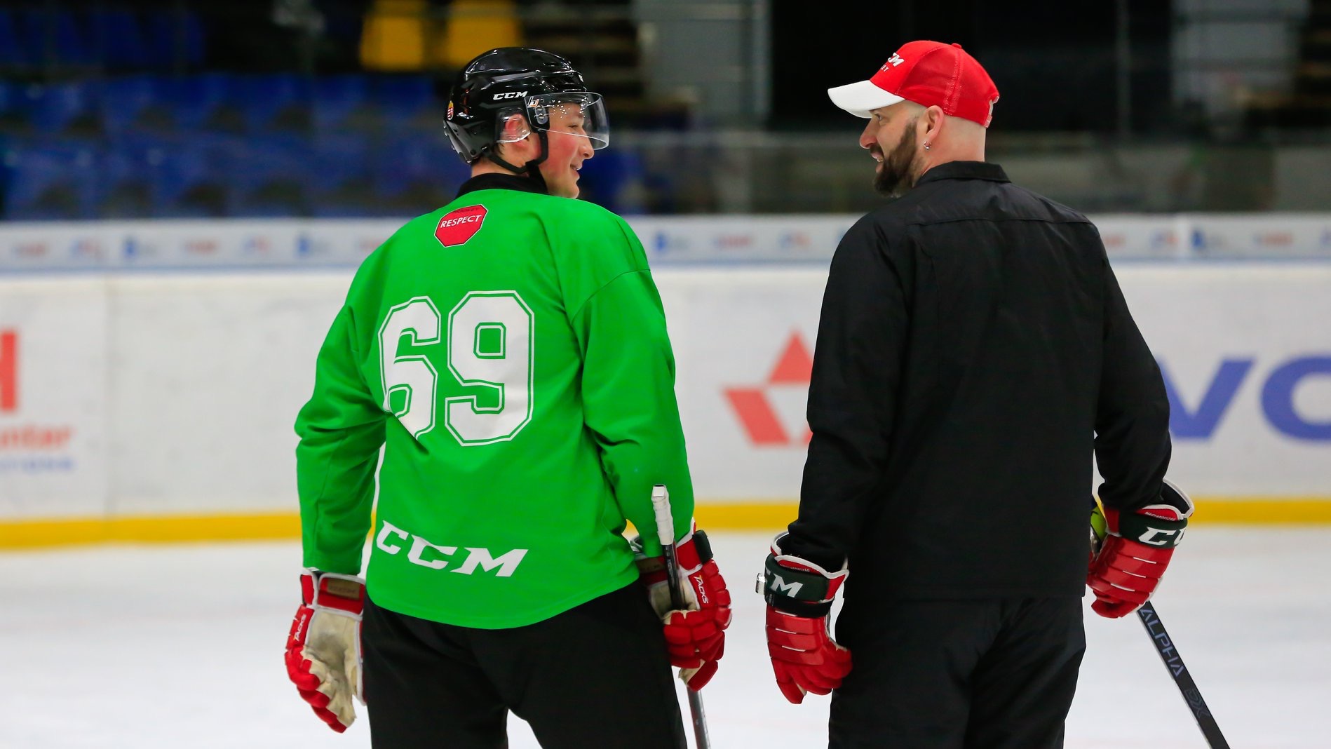 Coach communicating directly with a player on the ice